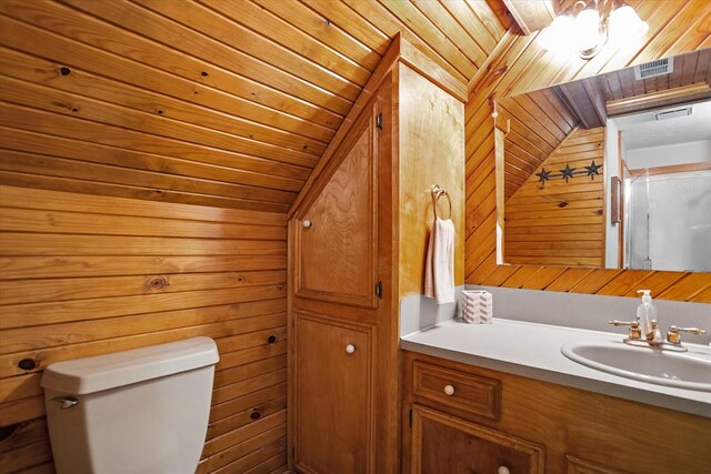 183 Holly Cir, Etoile, TX 75944 - bathroom featuring toilet, wooden walls, and vanity
