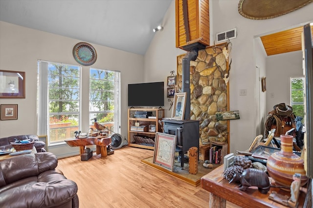 183 Holly Cir, Etoile, TX 75944 - living room with a wood stove, healthy amount of natural light, wood finished floors, and high vaulted ceiling