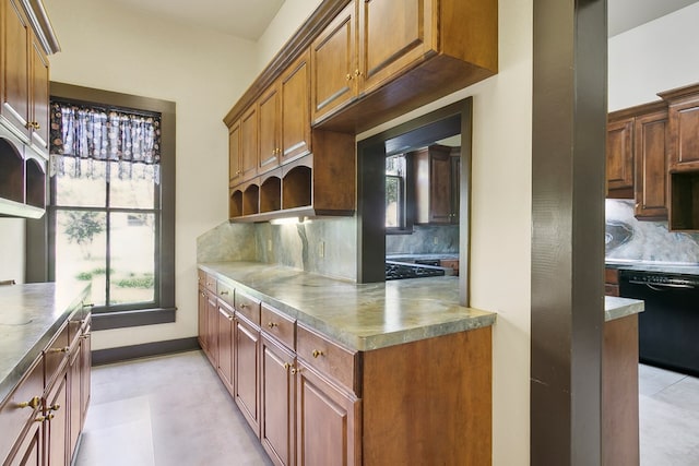 kitchen featuring black dishwasher and backsplash