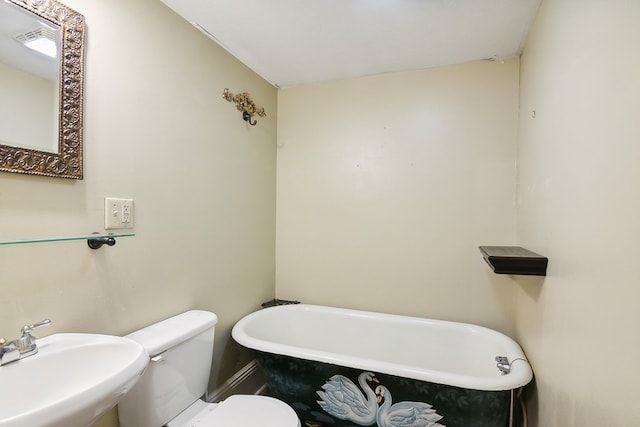 bathroom with sink, a bathtub, and toilet