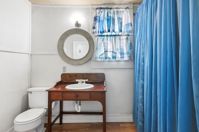 bathroom with sink, wood-type flooring, toilet, and walk in shower