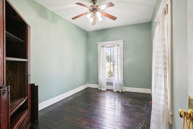 spare room featuring ceiling fan and dark hardwood / wood-style flooring