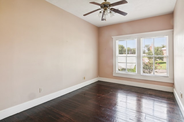 spare room with dark hardwood / wood-style flooring and ceiling fan