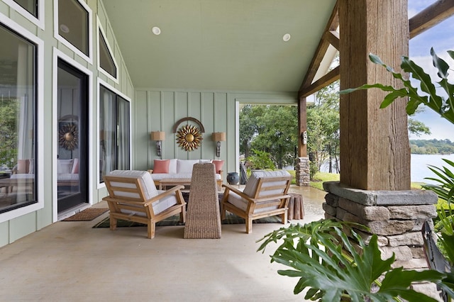 view of patio with outdoor lounge area and a water view