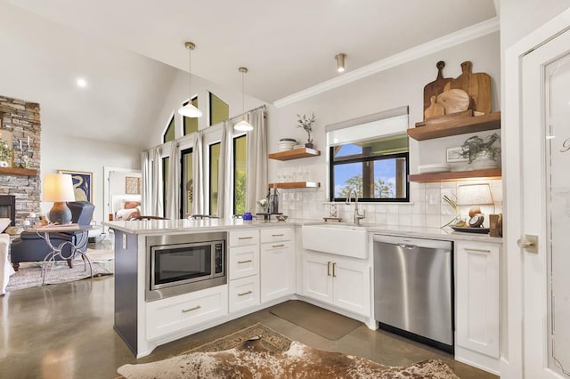 kitchen with white cabinets, pendant lighting, appliances with stainless steel finishes, and tasteful backsplash