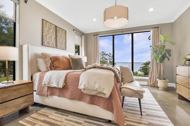 bedroom featuring concrete flooring, a water view, and ornamental molding