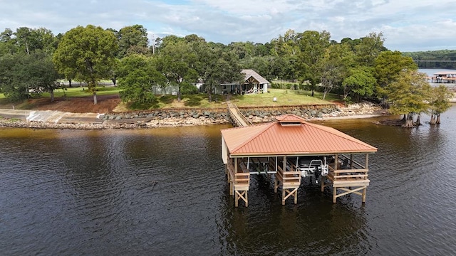 view of dock featuring a yard and a water view