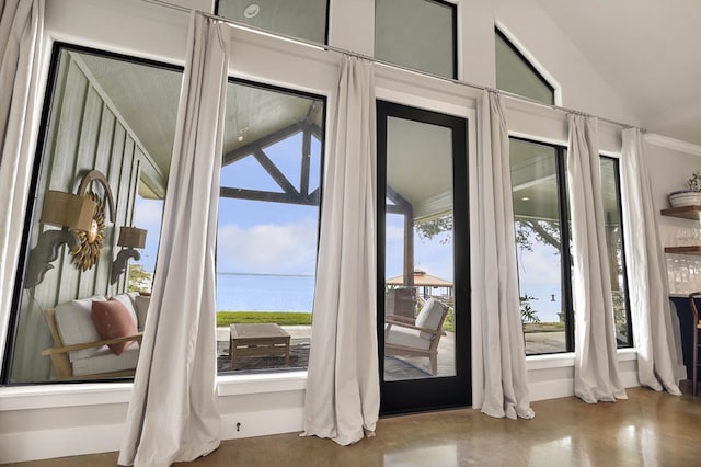 entryway featuring a water view and lofted ceiling