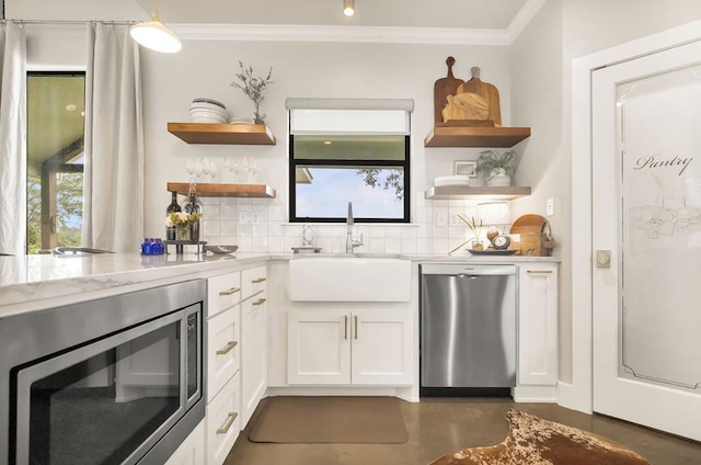 bar with white cabinets, sink, ornamental molding, tasteful backsplash, and stainless steel appliances