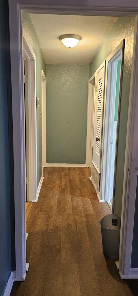 hallway with dark wood-type flooring