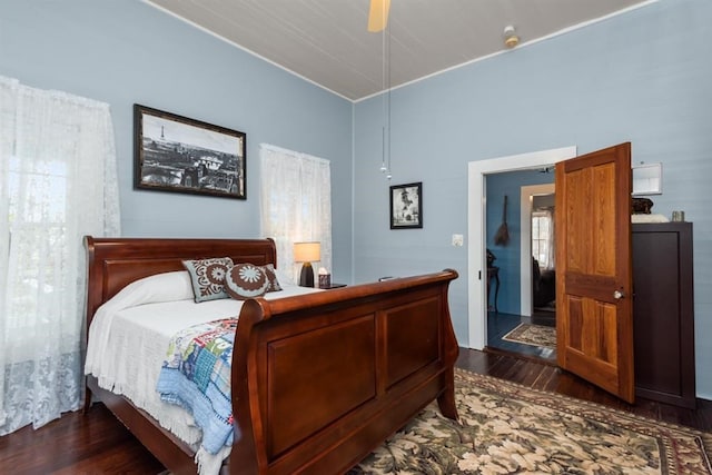 bedroom with ceiling fan and dark wood-type flooring