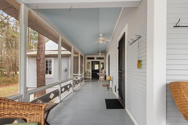 sunroom featuring ceiling fan and lofted ceiling