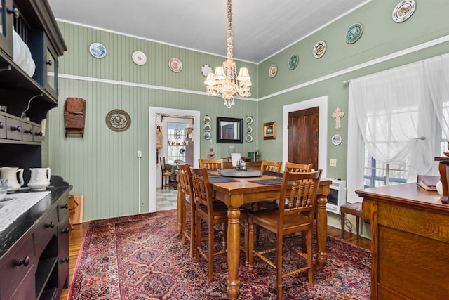 dining room featuring hardwood / wood-style floors and an inviting chandelier