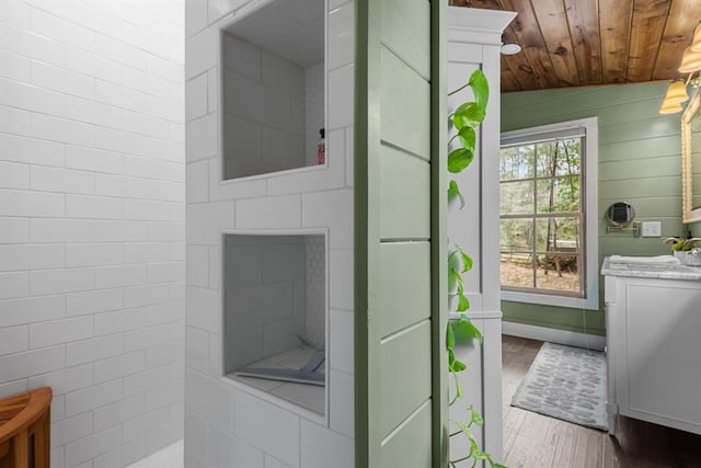 bathroom featuring wooden ceiling, sink, wooden walls, vaulted ceiling, and wood-type flooring