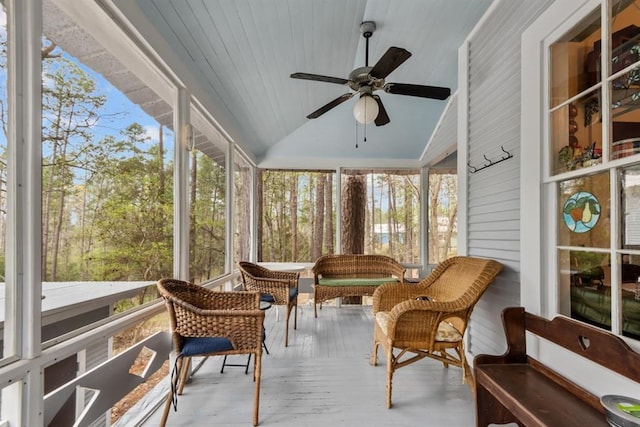 sunroom with ceiling fan, lofted ceiling, and wood ceiling