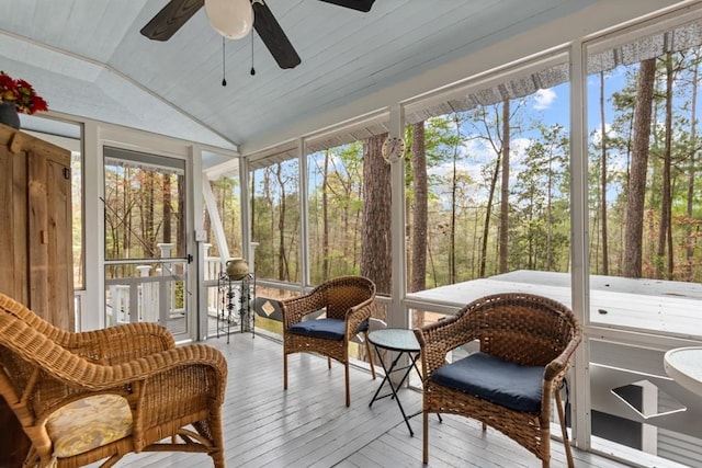 sunroom / solarium with wood ceiling, ceiling fan, a healthy amount of sunlight, and lofted ceiling