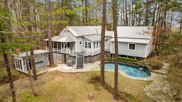 back of house with a swimming pool side deck