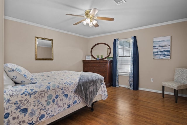 bedroom with ornamental molding, ceiling fan, and dark wood-type flooring