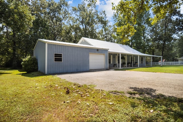 exterior space featuring a porch, a garage, and a front lawn