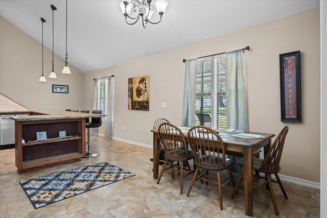 dining area with vaulted ceiling and an inviting chandelier