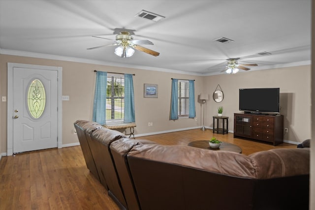 living room with ceiling fan, wood-type flooring, and ornamental molding