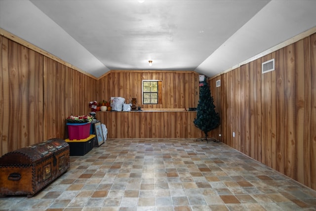 bonus room featuring wooden walls and lofted ceiling