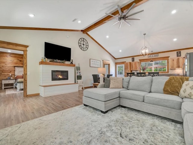 1003 Holubec St, Diboll, TX 75941 - living area featuring ceiling fan, light wood-style floors, a glass covered fireplace, a chandelier, and baseboards