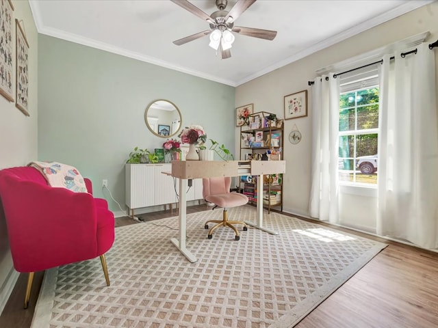 office space with baseboards, wood finished floors, ceiling fan, and crown molding