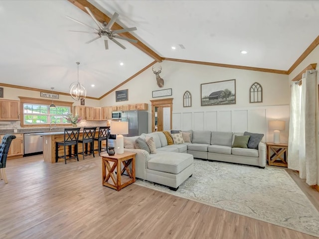 living area with high vaulted ceiling, beamed ceiling, ceiling fan with notable chandelier, and light wood-style flooring