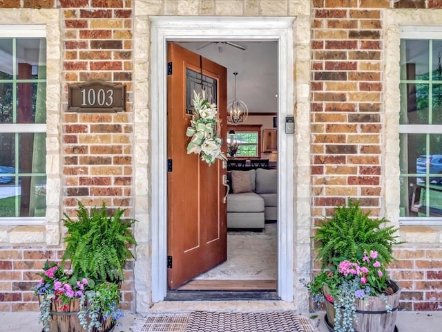 doorway to property with brick siding