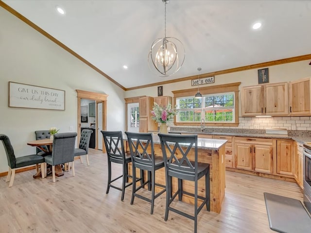 kitchen with light brown cabinetry, lofted ceiling, crown molding, and decorative backsplash