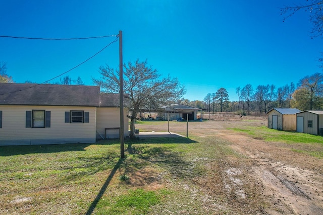 view of yard featuring a shed and a carport