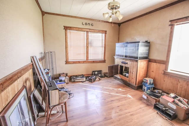 interior space featuring ceiling fan, crown molding, and hardwood / wood-style floors