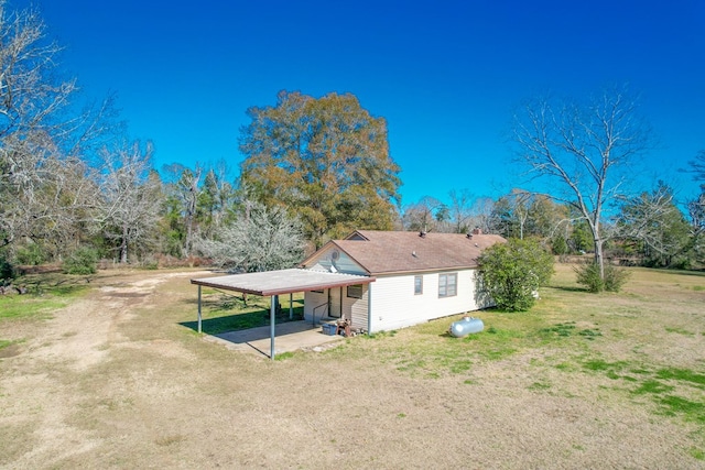 back of property with a lawn