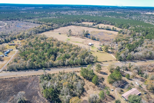 birds eye view of property featuring a view of trees