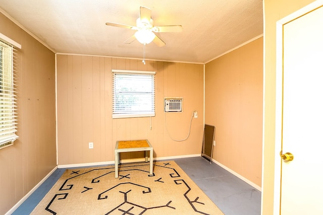 496 County Road 486, Broaddus, TX 75929 - unfurnished room featuring ceiling fan, an AC wall unit, ornamental molding, baseboards, and finished concrete flooring