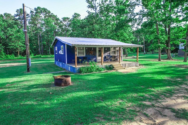 496 County Road 486, Broaddus, TX 75929 - view of front facade with a front yard and metal roof
