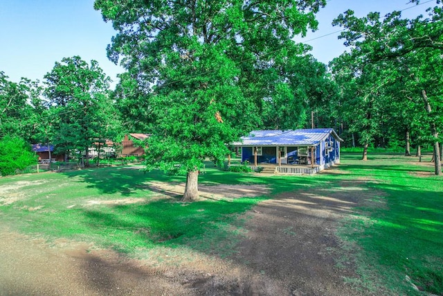 496 County Road 486, Broaddus, TX 75929 - view of green lawn featuring covered porch