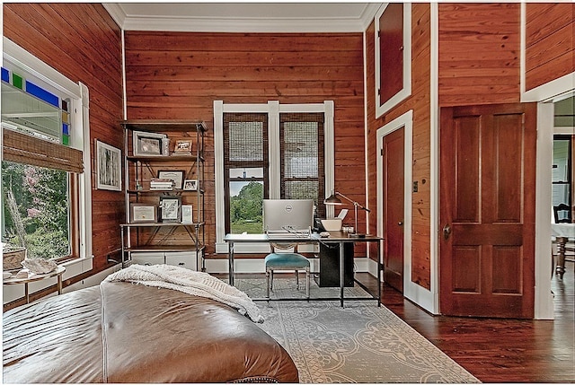 unfurnished office featuring ornamental molding, dark hardwood / wood-style flooring, and wooden walls