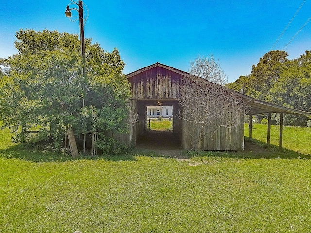 view of outdoor structure featuring a lawn