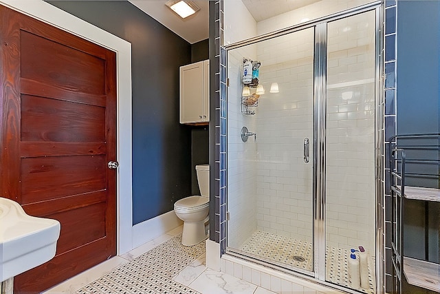 bathroom featuring an enclosed shower, toilet, and sink