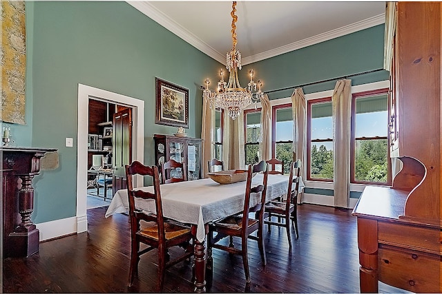 dining space featuring dark hardwood / wood-style flooring, a notable chandelier, and ornamental molding