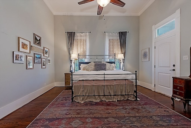 bedroom featuring dark hardwood / wood-style flooring, ceiling fan, and crown molding