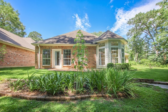 120 Shady Springs Bnd, Lufkin, TX 75901 - back of house featuring a yard, brick siding, and roof with shingles
