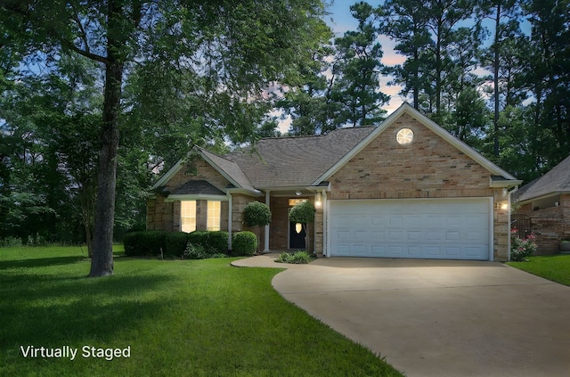 120 Shady Springs Bnd, Lufkin, TX 75901 - view of front facade with driveway, a front lawn, a garage, brick siding, and a shingled roof