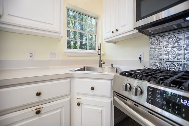 120 Shady Springs Bnd, Lufkin, TX 75901 - kitchen featuring appliances with stainless steel finishes, white cabinetry, light countertops, and decorative backsplash