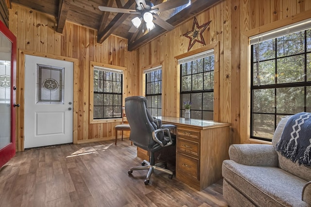 office space featuring lofted ceiling with beams, wooden walls, ceiling fan, and dark wood-style flooring