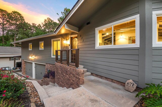 671 Lakeshore Dr, Brookeland, TX 75931 - view of exterior entry with an attached garage