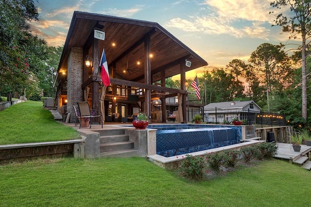 671 Lakeshore Dr, Brookeland, TX 75931 - pool at dusk with a patio and a wooden deck