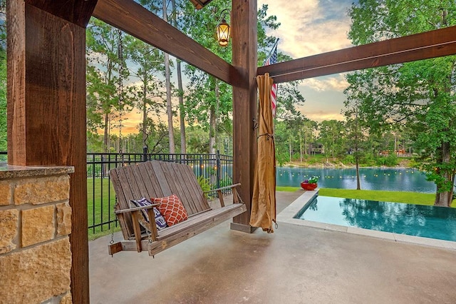 671 Lakeshore Dr, Brookeland, TX 75931 - view of patio / terrace with an infinity pool and a water view